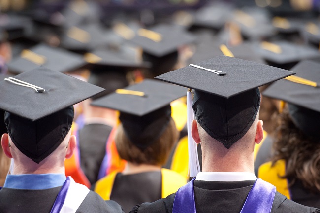 Students wearing graduation caps and gowns